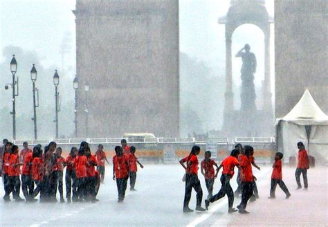School students are seen playing during heavy rainfall at Kartavya Path