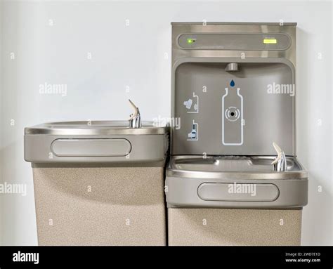 Water bottle refilling station with twin drinking fountains isolated by ...
