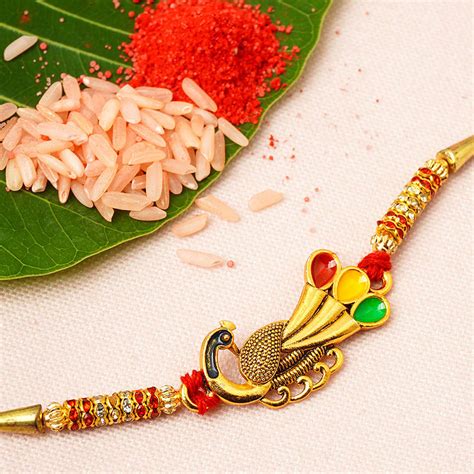 Buy Online Gold Colorful Feather Peacock Rakhi -Urmika – Ferosh