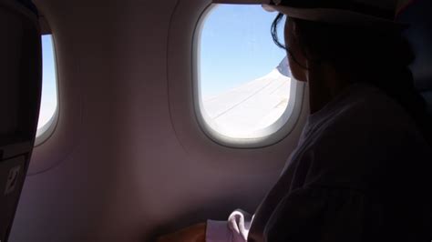 Jordan, 2022 - Woman looks out the window of an flying airplane wings ...