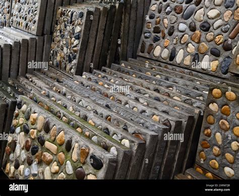 A pile of concrete tiles filled with rocks on top Stock Photo - Alamy