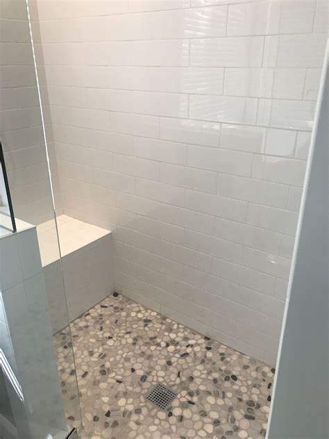 White Subway Tile Shower with Pebble Stone Floor