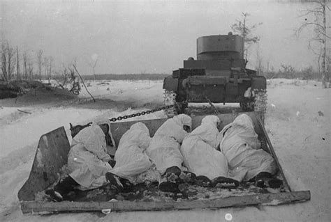 Soviet KhT-130 flamethrower tank (based on the T-26) tows a sled with ...