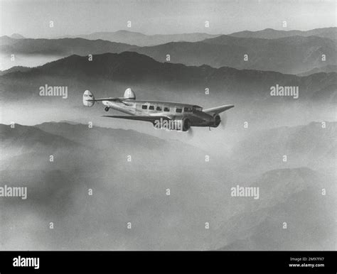 Lockheed L-10 Electra above misty hills Stock Photo - Alamy