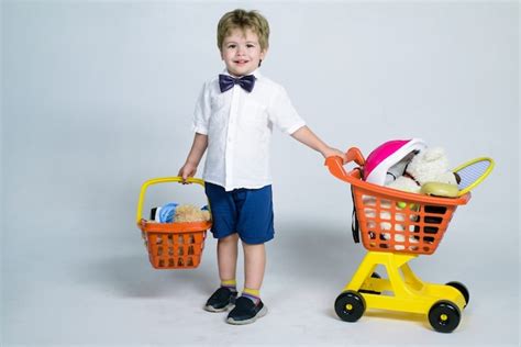 Shopping discount sale concept cheerful little boy with shopping cart ...