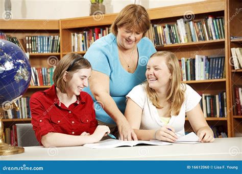 Friendly Teacher Helping Students Stock Photo - Image of notebook ...