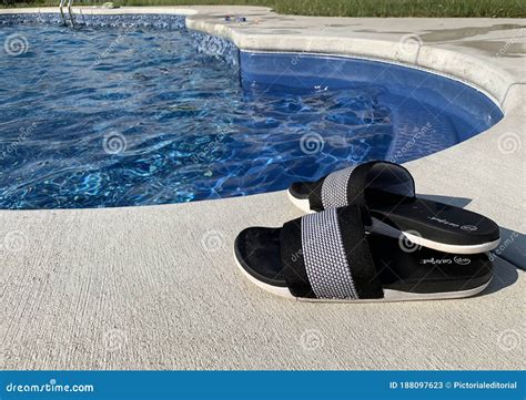 Pair of Shoes Left by an Inground Pool on a Sunny Day Editorial Stock ...