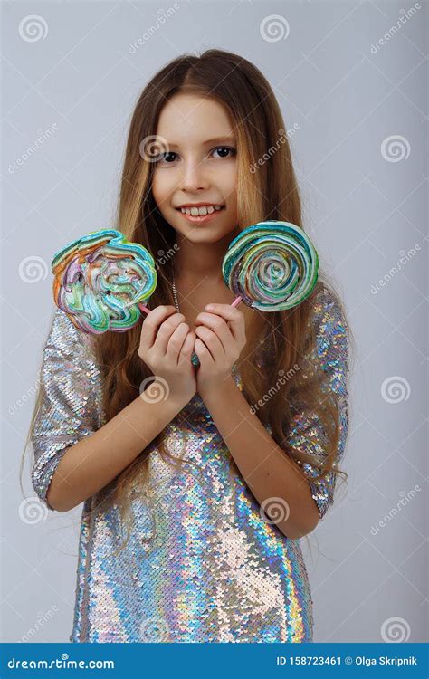 Beautiful Girl Smiles and Holds a Lolly in Her Hands. a Marshmallow ...
