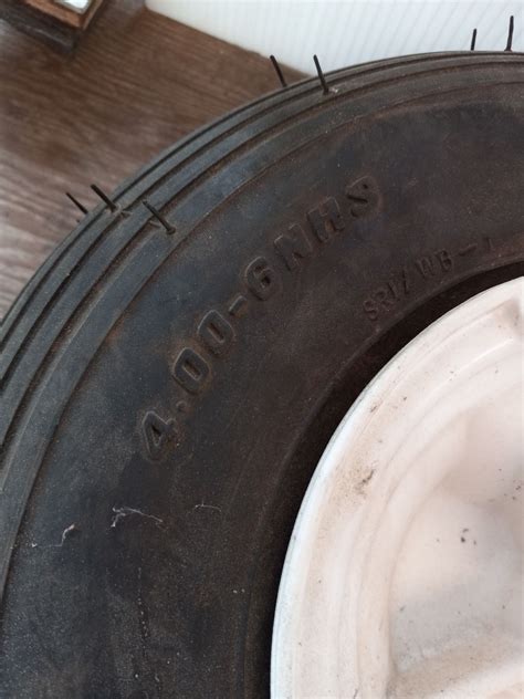 TWO MATCHING 4.00-6NHS TIRES ON RIM. ONE 4.80/4.00-8 TIRE ON RIM