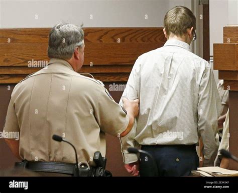 Jake Evans, right, is walked out of a courtroom by Parker County ...