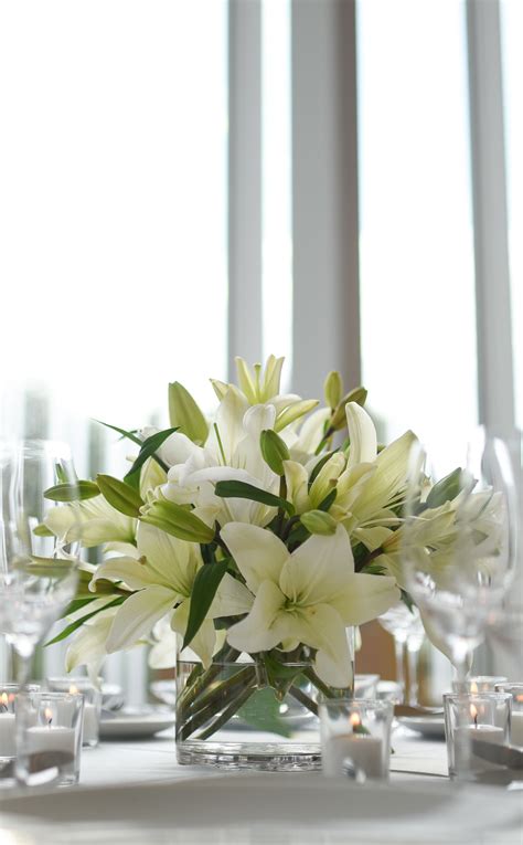 Crisp white lily centerpiece at the BK Botanical Garden Atrium. Modern ...