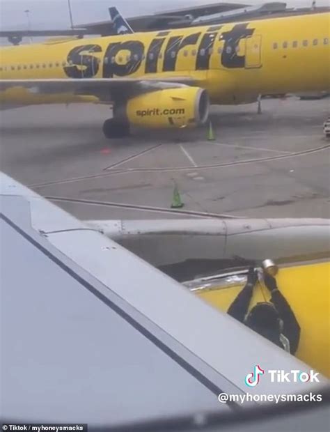 Spirit Airlines passenger films an employee putting tape on the plane ...