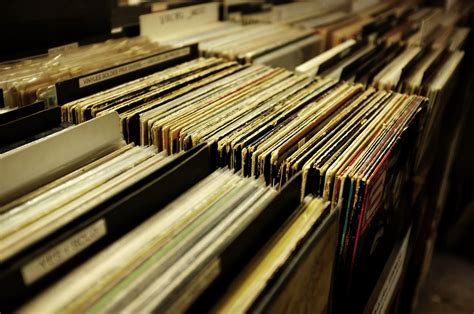 vinyl records lined up on the shelf of a music store, vinyl collection ...