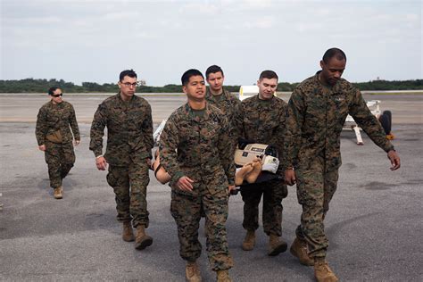 Navy, Army, and Air Force personnel perform en-route medical care training
