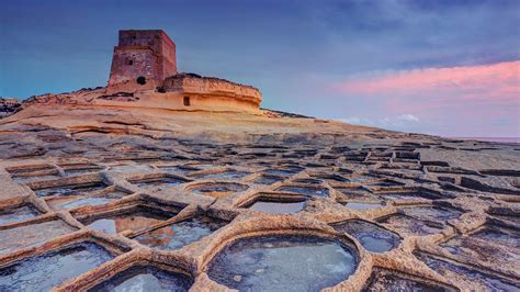 Watchtower and salt pans at sunset, Xlendi, Gozo Island, Malta ...