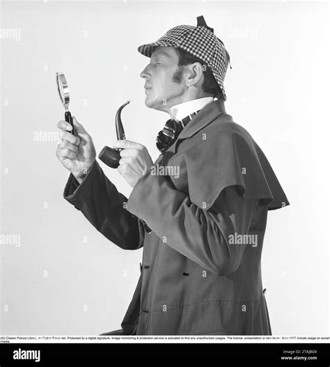 Playing detective. A man dressed in the typical clothes as the famous ...
