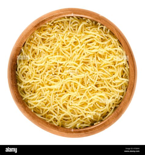 Filini short cut pasta in wooden bowl. Italian miniature noodles with ...