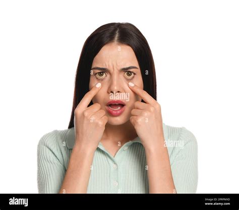 Woman checking her health condition on white background. Yellow eyes as symptom of problems with ...