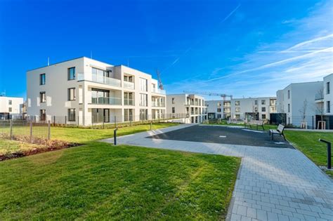 Modern residential complex with green areas and construction crane on ...
