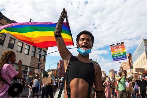 People hold signs during the Berlin Pride 2020 event, in Berlin ...