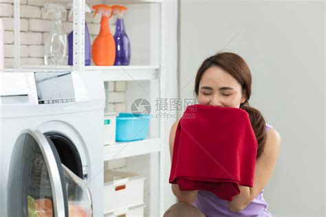 亚洲女家庭主妇洗干净后从衣服中闻到芳香味年轻女在做高清图片下载-正版图片506689534-摄图网