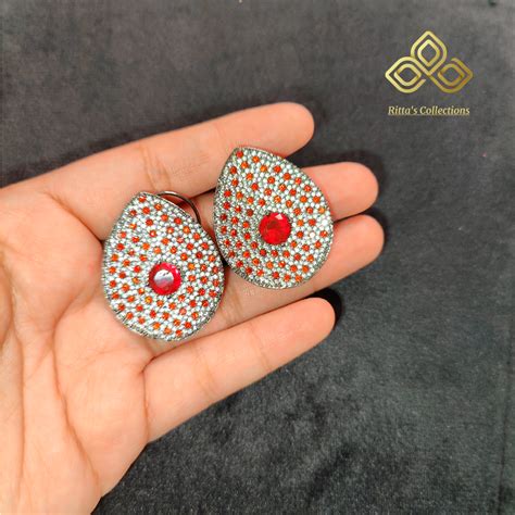 Premium Invincible Setting American Diamond Studs, Shade of Orange ...