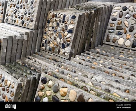 A pile of concrete tiles filled with rocks on top Stock Photo - Alamy