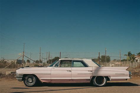 Download Classic Pink Cadillac on an open road Wallpaper | Wallpapers.com