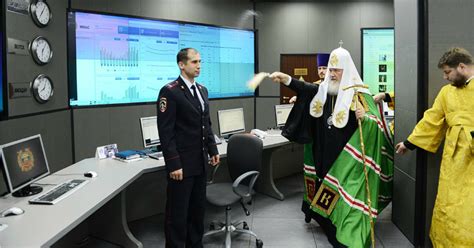 Images Of Russian Priest Blessing PC With Holy Water To Fight ...