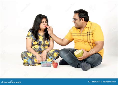 Man is Eating Watermelon Pregnant Wife with Sitting on the Floor Stock ...