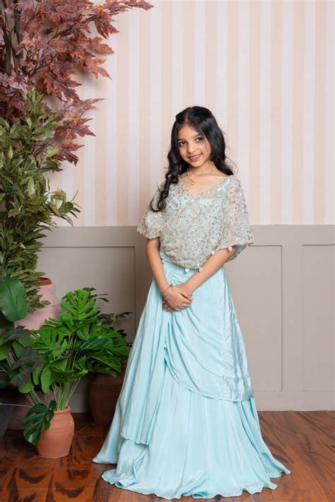 Twirl into elegance with this dreamy sea green cape top and lehenga se ...