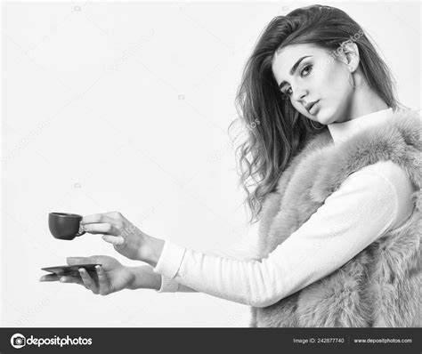 Enjoy aroma and taste hot coffee. Woman fur coat drink coffee. Elite ...