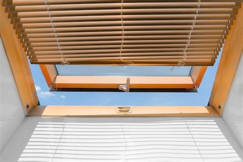 Mansard roof window with shutter blinds | Premium Photo