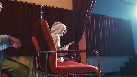 Person practicing public speaking in an auditorium with a single ...