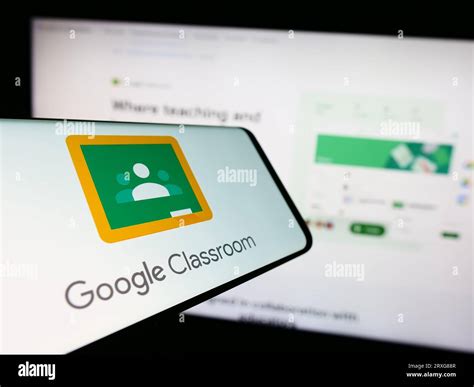 A phone displaying a Google logo is held up to a screen displaying a Wiz logo