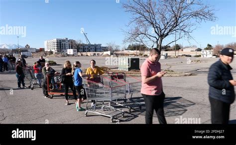 People stand in lines at an Upper East Side grocery store in New York.