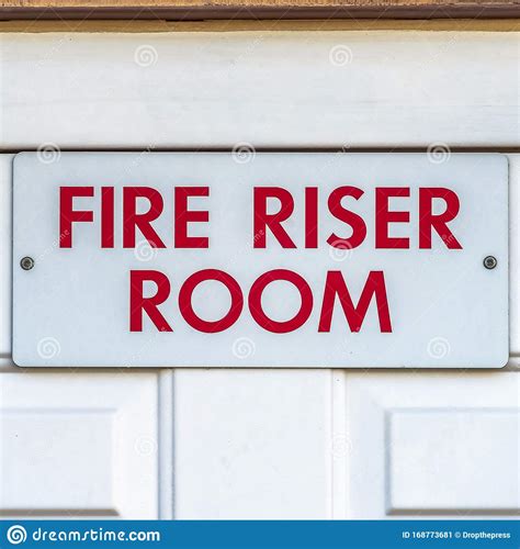 Square Close Up of the Fire Riser Room with White Wooden Door of a ...