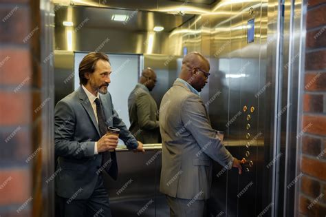 Pressing button. dark-skinned man pressing button in elevator while ...