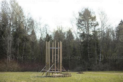 Construction in park. Construction of playground on grass. Installation of parts of structure ...