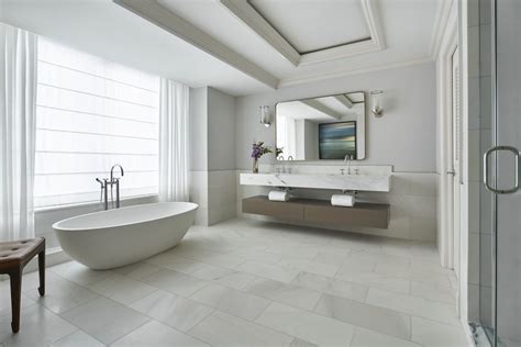 The Ritz-Carlton bath mat hung over standing bathtub