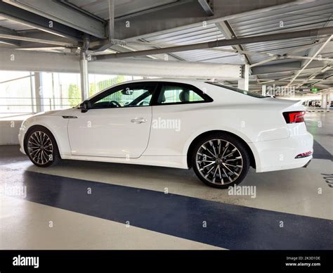 Basel, Switzerland - Sep 22, 2022: Lateral lower view of new white luxury Audi German car coupe ...