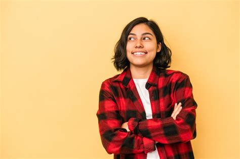 Young latin woman isolated on yellow background smiling confident with ...