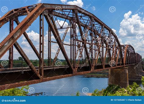 Old Rusty Truss Bridge With Moving Freight Train Over The Red Ri ...
