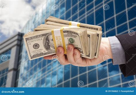 Male Hand Holding Stack of Cash with Corporate Building Stock Photo ...