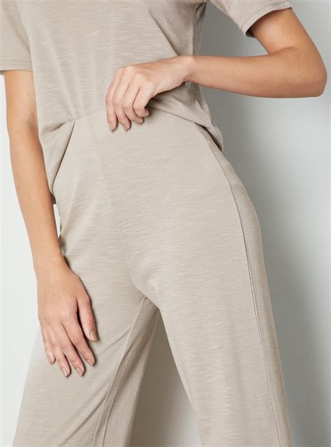 Buy Women Solid Wide Leg Trousers Online at just Rs. 799.0 ...