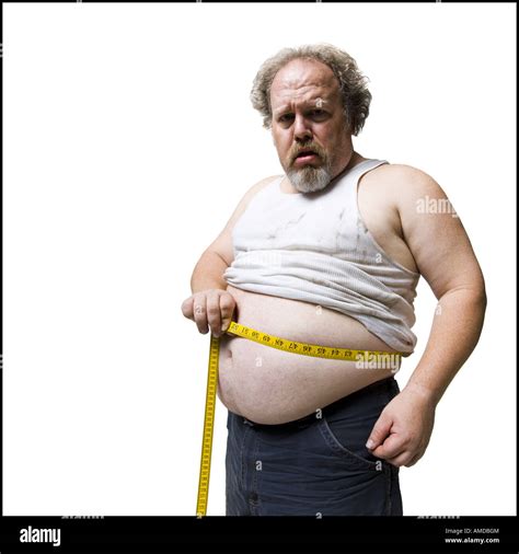 Obese man measuring waist with tape measure Stock Photo - Alamy