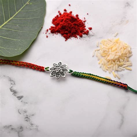 Rakhi with OM designed on Flower – VerveJewels
