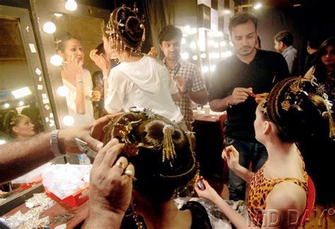 Mirror mirror on the wall: Amidst the chaos, models get ready before ...