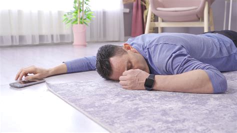 The man lying on the floor at home faints, has a heart attack. The man ...