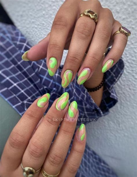 https://www.livethatglow.com/wp-content/uploads/2023/12/neon-green-swirl-almond-nails.jpg